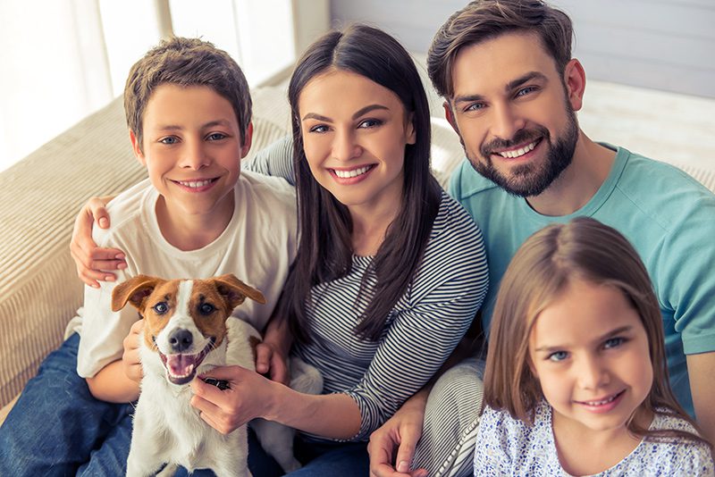 Happy Family And Dog Inside Home